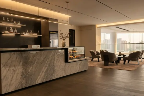 Desain interior lounge dan bar kafe mewah di showroom Denza Haka Pondok Indah dengan meja marmer eksklusif, pencahayaan hangat, dan ruang tunggu yang nyaman.